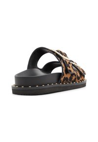 Leopard print slide sandals with black leather accents, wide straps, goldtone studs along the sole, and a textured black footbed.