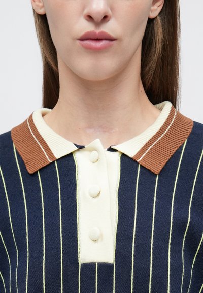 Πόλο μπλουζάκι με ναυτικά ριγέ, που διαθέτει καφέ γιακά και ανοιχτό πράσινες κάθετες ρίγες, με τρία μπροστινά κουμπιά και υφή φινιρίσματος.