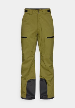 Oliwkowe spodnie narciarskie wykonane z wytrzymałego materiału, z czarnymi akcentami na kolanach i zamykanymi na zamek kieszeniami z przodu.