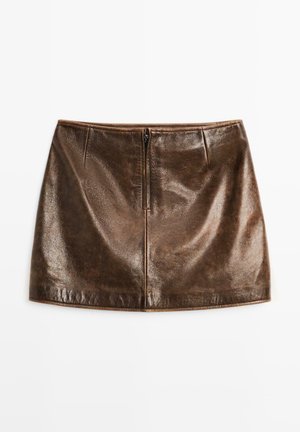 Brown leather mini skirt with a smooth texture, featuring a centered zipper closure and stitch detailing along the waist and hem.