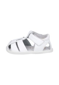 Sandalias de cuero blanco con m últiples recortes, cierre de tira de Velcro y plantilla texturizada para mayor comodidad. Suela plana de goma.