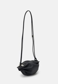 Black leather shoulder bag with a rounded design, soft texture, zipper closure, and adjustable, thin cord straps.