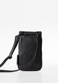 Borsa a tracolla in pelle nera con chiusura a zip e forma rettangolare sottile. Presenta una tracolla removibile e una superficie liscia.