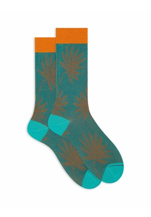Türkise Socken mit orangenen Bündchen. Enthält ein braunes Blättermuster. Einfarbige türkisfarbene Zehen- und Fersenabschnitte, durchgehend gerippte Struktur.