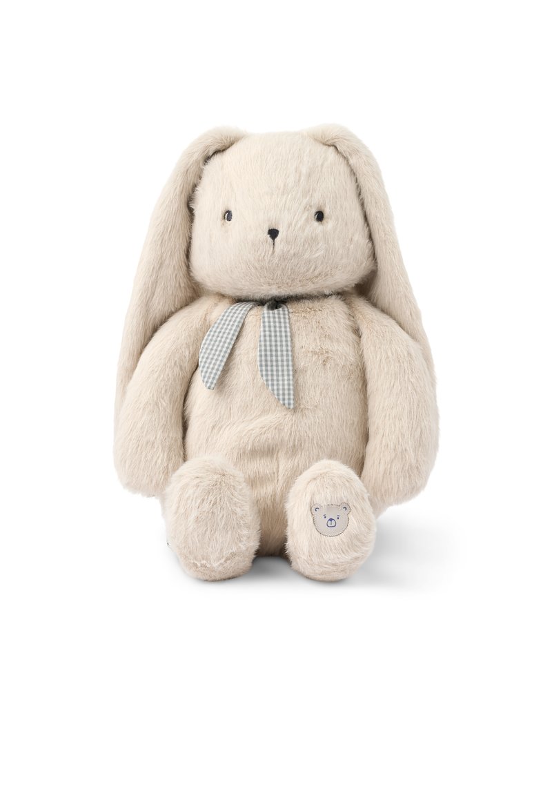 Bunny de peluche suave en color beige, con orejas largas, ojos negros, un lazo de cinta a cuadros y un pequeño parche de cara de oso en su pie.