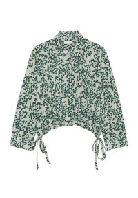 Koszula z długim rękawem i kołnierzykiem w zielone kropki na jasnym materiale, z kieszonką z przodu i regulowanymi sznurkami na dole.