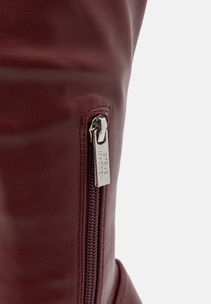 steve madden brown boots with red zipper