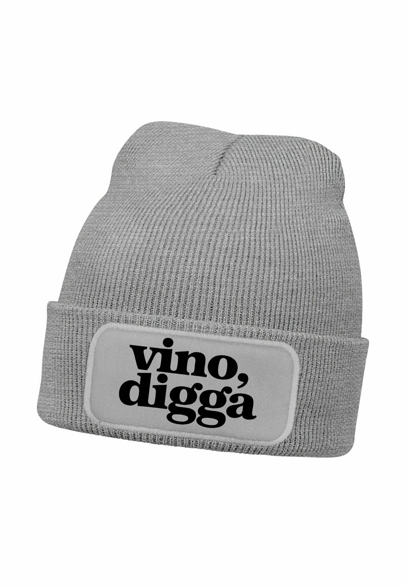 Gray knit beanie with a folded cuff, featuring a rectangular white patch with black text that reads "vino, digga." Text is bold and prominent.