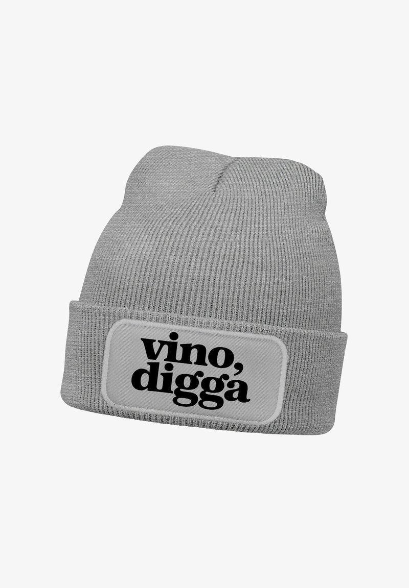 Gray knit beanie with a folded cuff, featuring a rectangular white patch with black text that reads "vino, digga." Text is bold and prominent.