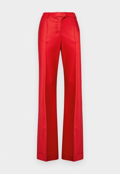 Red wide-leg trousers made of smooth fabric with a high waist and belt loops. Features sharp creases along the front for structured design.