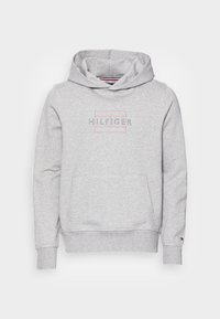 Felpa grigia con cappuccio dotata di tasca frontale e cordini, con il logo "HILFIGER" in testo contornato. Tessuto morbido in misto cotone.