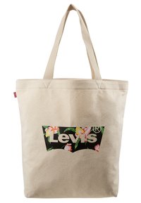 Tygväska i beige med blommig grafik. Har en svart Levi's-logotyp inuti en karaktäristisk form. Stadiga plana remmar för enkel bärning.