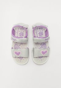 Silberne und lila Sandalen mit Klettverschlüssen, Herzakzenten und einer gepolsterten Innensohle mit Blumen- und Weltraummustern. Größe 28.