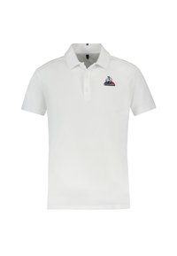 Polo blanc en coton, avec un col à trois boutons, des manches courtes et un logo sur la poitrine gauche. Design simple et classique.