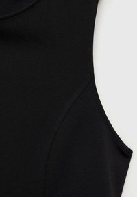 Black sleeveless top featuring smooth fabric, rounded neckline, and seam detailing along the shoulder for a fitted design.