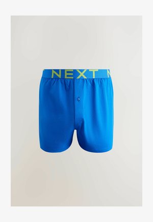 Blå herreboxershorts med en glat tekstur og knaplukning foran. Taljebåndet har "NEXT" i kontrasterende, lys grøn skrift.