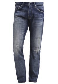 Męskie niebieskie dżinsy z denimu z wyblakłym efektem i przetarciami na udach oraz kolanach, z przednimi kieszeniami i szlufkami na pasek.