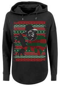 Crna dukserica s pletenim uzorkom u crvenoj, zelenoj i bijeloj boji, koja prikazuje lik s šeširom i nožem. Dugi rukavi i prednji džep.