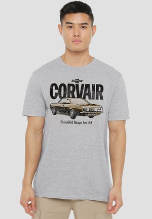Gray cotton t-shirt featuring a Chevrolet Corvair graphic in black and gold, with 'Beautiful Shape for '65' text. Short sleeves, crew neck.