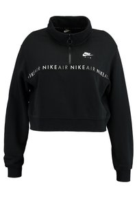 Svart Nike cropped sweatshirt med hög krage, fyrdelad dragkedja och vitt logotryck på bröstet och ärmen. Mjukt, texturerat tyg.