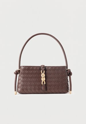 Dark brown woven leather handbag with a curved handle, gold chain detail at center, and knots at handle ends against a light background.