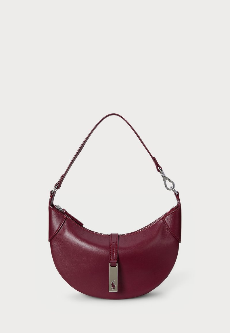 Burgundy leather handbag with a curved design, a top zipper closure, and a silver hardware accent featuring a brand logo.