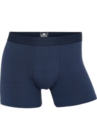 Marineblå boxer-shorts lavet af blødt stof, med forstærket søm og en elastisk talje med mærkenavnet "DOVRE" prentet.