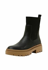 Bottes chelsea à talons épais en cuir noir avec tige textile à côtes, semelle en caoutchouc marron contrastante et tirant à l'arrière pour un enfilage facile.