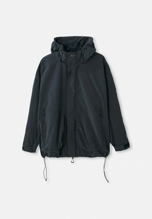 Black hooded jacket made of lightweight fabric. Features a zip closure, drawstrings, and side pockets with zippers. Loose fit design.
