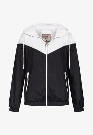 Czarna i biała kurtka przeciwwiatrowa z kapturem, zapinana na zamek, z elastycznymi mankietami i bocznymi kieszeniami na zamek. Charakteryzuje się wyraźnym wzorem w blokach kolorów.