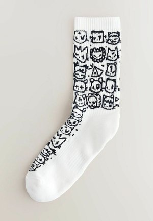 White sock featuring a black graphic pattern of various cartoon characters, ribbed cuff, and smooth texture on the body.