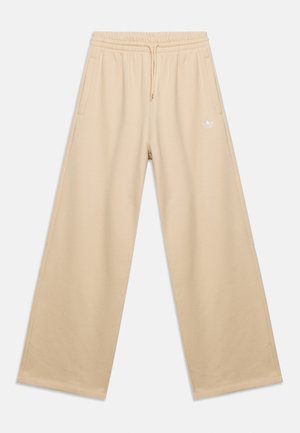 Beige bredbenede joggingbukser med elastisk talje, snøre, sidelommer og lille hvidt logo på venstre lår.