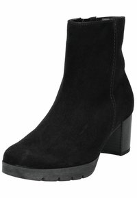 Stivale alla caviglia nero in suede, caratterizzato da una punta arrotondata, tacco a blocco medio e dettagli cuciti sui lati. Suola in gomma piatta.