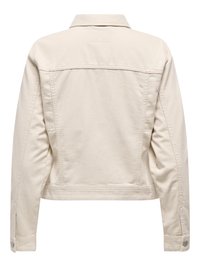 Žiūrint iš nugaros, smėlio spalvos džinsinė striukė su apykakle, ilgomis rankovėmis ir užsegamais rankogaliais. Paprastos siuvimo detalės ant nugaros skydelio.