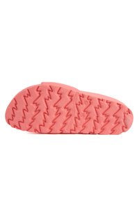 Semelle de chaussure en caoutchouc rose avec un motif de traction en zigzag, surface texturée, bords arrondis et marquages de marque visibles pour une adhérence et une flexibilité optimales.