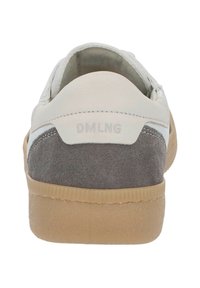 Rear view of gray and white sneaker with suede detailing and gum sole, featuring "DMLNG" branding on heel tab.