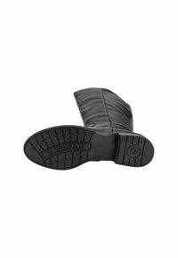 Bottine en cuir noir avec une semelle plate et texturée. La partie supérieure est élégante, avec un design épuré et un bout arrondi. Rehaussée de coutures discrètes.