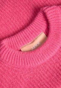 Pink wool sweater featuring a thick ribbed collar and a textured body. Label is visible with the brand name "JJXX" in white on a light background.