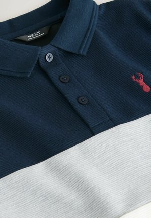 Tricou polo în dungi albastru închis și gri deschis, realizat dintr-un material texturat, având un guler cu trei nasturi și un mic logo cu un homar roșu brodat.