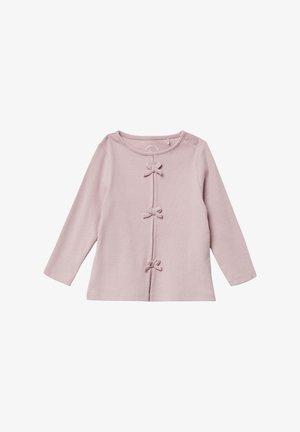 Light pink long-sleeve top with a ribbed texture and four bow accents down the front. Features a rounded neckline and side button closure.