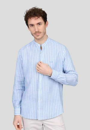 Chemise à manches longues bleu clair avec des rayures blanches verticales, col boutonné et logo subtil. Tissu en coton avec une texture lisse.