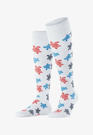 Kniehoge witte sokken met een herhalend patroon van rode, blauwe en zwarte schildpadden. Zacht materiaal met een gladde textuur en geribde boorden.