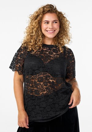 Black lace top with short sleeves, featuring floral patterns and a semi-sheer design. Smooth texture and round neckline.