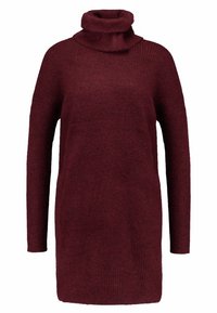 Maglione oversized bordeaux con un alto colletto a imbuto piegato, texture a costine e maniche lunghe, caratterizzato da una vestibilità comoda e rilassata.