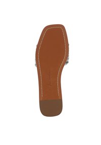 Suola di scarpa in pelle marrone con una texture liscia, forma arrotondata e dettaglio di cucitura bianca lungo i bordi; nome del marchio impresso.