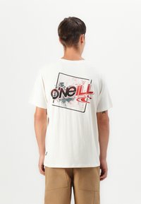 White cotton t-shirt featuring a colorful graphic on the back, including red and black lettering and a splatter design.