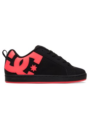 Black low-top sneaker with neon red sole and large neon red DC logo on the side, black laces, and pull tab at the heel.