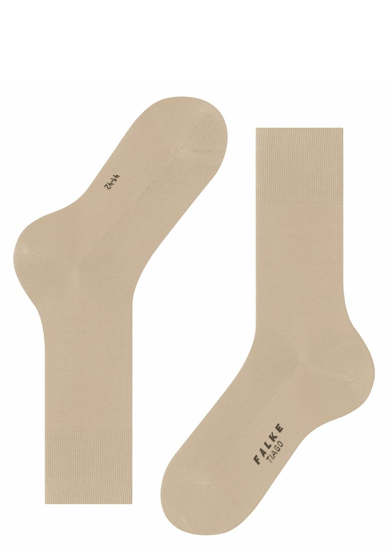 Calcetines de algodón beige con acentos acanalados en la parte superior, una textura suave y áreas reforzadas en el talón y la puntera; etiquetados como "FALKE TIAGO."