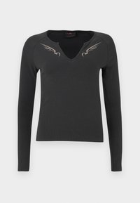 Maglietta nera a maniche lunghe con scollatura a V e texture a coste, con due design di ali argentate sulle spalle anteriori.