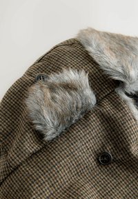 Brown checked coat featuring a soft gray fur collar, black button details, and a textured fabric for warmth and style.